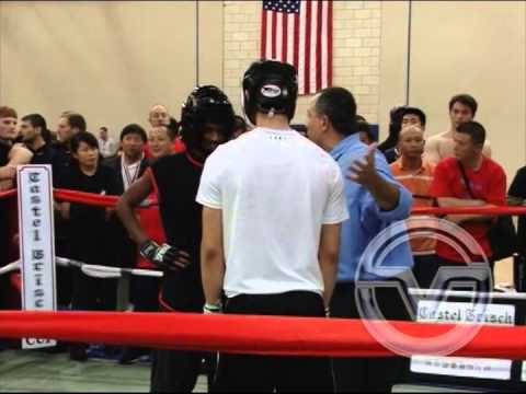 Judge Gus Kaparos officiating a match between two fighters at The US Open Martial Arts Championship